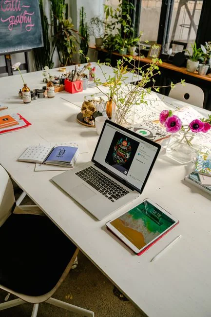Flat lay of employer branding materials on an office table, showcasing marketing and design.